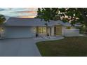 Charming single-story home with a well-manicured lawn, driveway, and a screened entryway that welcomes you in at 2442 Rio De Janeiro Ave, Punta Gorda, FL 33983