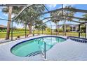 Inviting screened-in pool area with a spacious pool, spa, and beautiful backyard views at 2442 Rio De Janeiro Ave, Punta Gorda, FL 33983