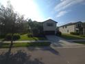 Charming two-story home with lush landscaping, well-maintained lawn, and a spacious driveway leading to a two-car garage at 2739 Sherman Oak Dr, North Port, FL 34289