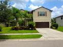 Inviting two-story home with a well-manicured lawn and a two-car garage, perfect for Gathering living at 2739 Sherman Oak Dr, North Port, FL 34289