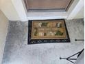 Charming 'Home Sweet Home' welcome mat placed in front of the entryway at 2739 Sherman Oak Dr, North Port, FL 34289