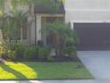 Charming two-story home featuring lush, well-maintained landscaping and healthy green lawn at 2739 Sherman Oak Dr, North Port, FL 34289