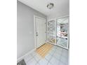 Welcoming foyer with tile flooring, front door, and closet with mirrored doors at 3122 Scranton St, Port Charlotte, FL 33952
