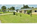 Lovely single-story home with a spacious front yard, mature trees, and a convenient covered carport at 3122 Scranton St, Port Charlotte, FL 33952