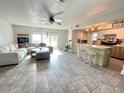 Open-concept living space with tile floors seamlessly connecting the living room and kitchen at 3122 Scranton St, Port Charlotte, FL 33952