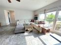 Bright living room with large windows, tile flooring, and a comfortable sectional sofa at 3122 Scranton St, Port Charlotte, FL 33952