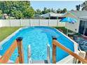 Inviting backyard pool with blue water, perfect for summer relaxation at 3122 Scranton St, Port Charlotte, FL 33952