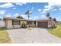 Inviting single-story home with a spacious driveway, attached garage, and well-kept landscaping at 315 Holly Rd, Venice, FL 34293