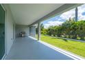 Large screened lanai with a barbecue grill and view of the backyard at 3302 Palm Dr, Punta Gorda, FL 33950