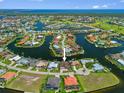 An aerial view of a waterfront community showcases the luxury homes with access to deep water at 3353 Sandpiper Dr, Punta Gorda, FL 33950