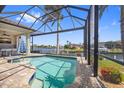 Screened-in pool area with an outdoor kitchen and a lovely view of the canal at 3353 Sandpiper Dr, Punta Gorda, FL 33950