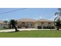 Charming single-story home with a well-kept lawn, tiled roof, and a welcoming driveway at 3398 Tripoli Blvd, Punta Gorda, FL 33950