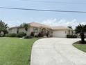 Lovely single-story home with a long driveway, attached garage, and beautifully landscaped front yard at 3398 Tripoli Blvd, Punta Gorda, FL 33950