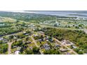 An aerial view of a community with lush greenery, highways, water views, and diverse housing options at 4702 Westwood Dr, Punta Gorda, FL 33982