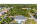 Aerial view of a home with a trampoline, above ground pool, and large trees in a fenced-in backyard at 4702 Westwood Dr, Punta Gorda, FL 33982