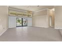 Open living space featuring large windows, sliding glass doors, and tile flooring at 5023 Key Largo Dr, Punta Gorda, FL 33950