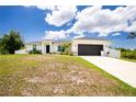 Charming single-story home showcasing a well-manicured lawn, two-car garage and a welcoming front entrance at 5532 Veracruz Ter, Port Charlotte, FL 33981
