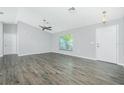 Bright and airy living room featuring stylish flooring, a ceiling fan, and natural light from a large window at 5532 Veracruz Ter, Port Charlotte, FL 33981