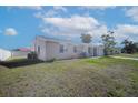 Well-maintained single-story home with a green lawn and a private, fenced backyard at 6850 S Biscayne Dr, North Port, FL 34287
