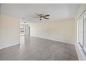 Bright living room with tile flooring, neutral walls, and a modern ceiling fan at 6850 S Biscayne Dr, North Port, FL 34287