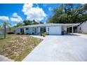 Charming single-story home with a blue exterior, well-kept lawn, attached garage and white trim at 7231 Elyton Dr, North Port, FL 34287