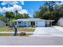 Charming single-story home with a blue exterior, well-kept lawn, attached garage and white trim at 7231 Elyton Dr, North Port, FL 34287