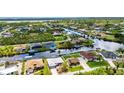Waterfront community with houses lining the canals and beautiful landscaping throughout at 9582 Arsipe Cir, Port Charlotte, FL 33981