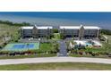 Aerial view of condos with tennis court, pool, and stunning water views, perfect for resort living at 101 N Marion Ct # 133, Punta Gorda, FL 33950