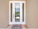A welcoming front door with decorative glass and a welcome mat at 10263 Shadow Run Cir, Punta Gorda, FL 33955