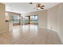 Spacious living room featuring neutral walls and tile floors, and ceiling fan at 10263 Shadow Run Cir, Punta Gorda, FL 33955