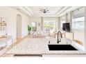 Open-concept kitchen with stone countertops and stainless steel appliances overlooking living area at 122 Arrow Ln, Rotonda West, FL 33947