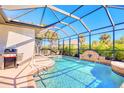 Inviting screened-in pool area with a water feature, perfect for relaxation at 122 Arrow Ln, Rotonda West, FL 33947