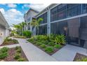 Charming exterior view of a condo building with lush greenery and a well-maintained walkway at 14257 Heritage Landing Blvd # 1115, Punta Gorda, FL 33955
