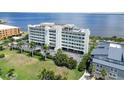 Gorgeous aerial view of the condo building with lush grounds and bay views at 1500 Park Beach Cir # 5E, Punta Gorda, FL 33950