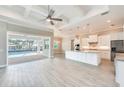 Open-concept living room and kitchen with modern finishes and access to the pool area at 15698 Meacham Cir, Port Charlotte, FL 33981