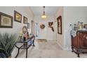 Inviting entryway featuring tile flooring, decorative accents, and a view of the front door at 1876 Birmingham Blvd, Punta Gorda, FL 33980