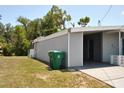 Side view of the house featuring a carport with parking and storage at 21275 Austin Ave, Port Charlotte, FL 33952