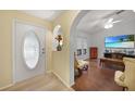 Bright foyer with decorative glass door and archway leading into the living area at 22353 Blanchard Ave, Port Charlotte, FL 33952