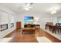 Open-concept living area featuring hardwood floors, a ceiling fan, and a dining space at 22353 Blanchard Ave, Port Charlotte, FL 33952