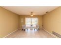 Cozy living room featuring tile flooring, chairs, and sliding glass doors at 238 Mark Twain Ln, Rotonda West, FL 33947