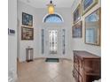 Bright entryway with decorative glass door, tiled floor, and elegant decor at 24312 Westgate Blvd, Port Charlotte, FL 33980