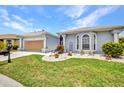 Inviting single-story home with a well-kept lawn and stylish landscaping at 24312 Westgate Blvd, Port Charlotte, FL 33980