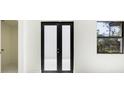 The front door of the home opens to a clean, bright entryway with a window and a view outside at 355 Milton St, Port Charlotte, FL 33954