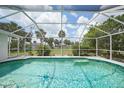 Screened pool with tiled trim and relaxing outdoor space at 4055 Alwick Ln, North Port, FL 34287