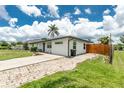 Single-story home with a brick driveway and freshly painted exterior at 416 Allen St, Punta Gorda, FL 33950