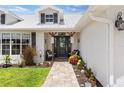 Inviting front porch with seating, decorative lanterns, a stone pathway, and tasteful landscaping at 425 Corrientes Cir, Punta Gorda, FL 33983