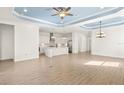 Open-concept living space featuring tile floors and a modern kitchen with white cabinets and stainless steel appliances at 43406 Boardwalk Loop, Punta Gorda, FL 33982