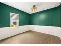 Cozy office space with wainscoting, stylish light fixture, and natural light from the window at 43406 Boardwalk Loop, Punta Gorda, FL 33982
