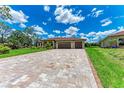 This property features a spacious, paved driveway, offering ample parking for guests and residents alike at 4380 Maddock Cir, North Port, FL 34286