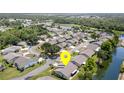 Lovely aerial view of a well-maintained residential area with lush landscaping and tranquil pond views at 541 Wekiva River Ct # 94, Englewood, FL 34223